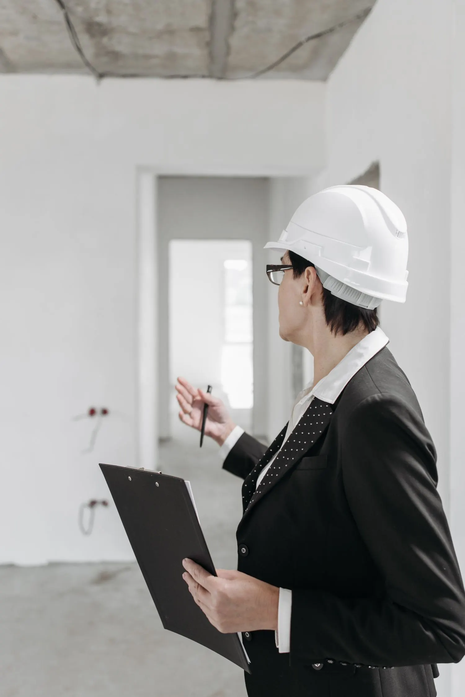 Professional inspecting unfinished interior work with clipboard